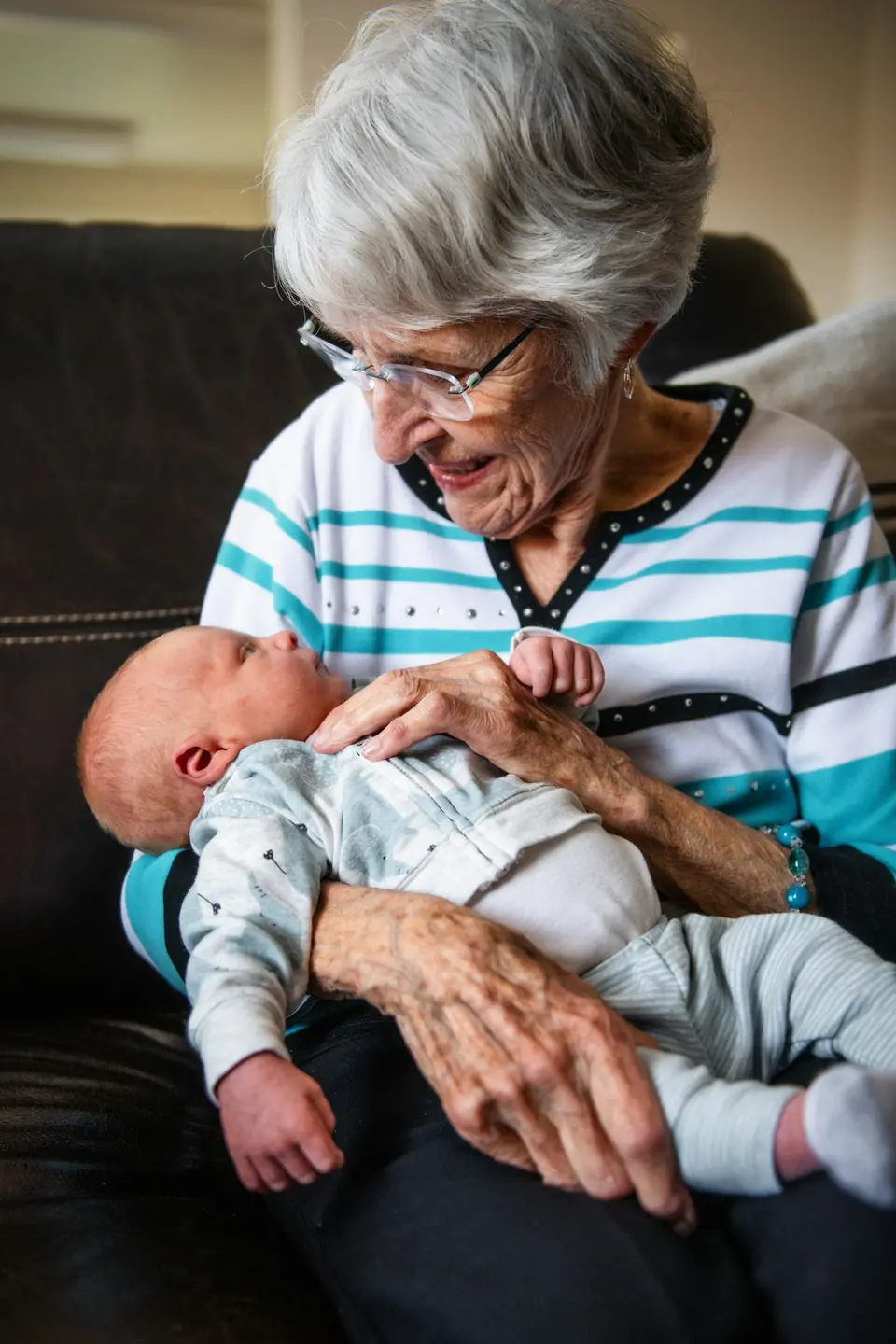 An older woman holding a newborn